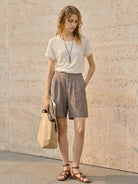 100% linen tee with rolled cuff sleeves and relaxed scoop neckline